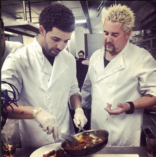Illustration for article titled Special Edition Caption Contest: What's Guy Fieri saying (or more likely, yelling) to Drake?